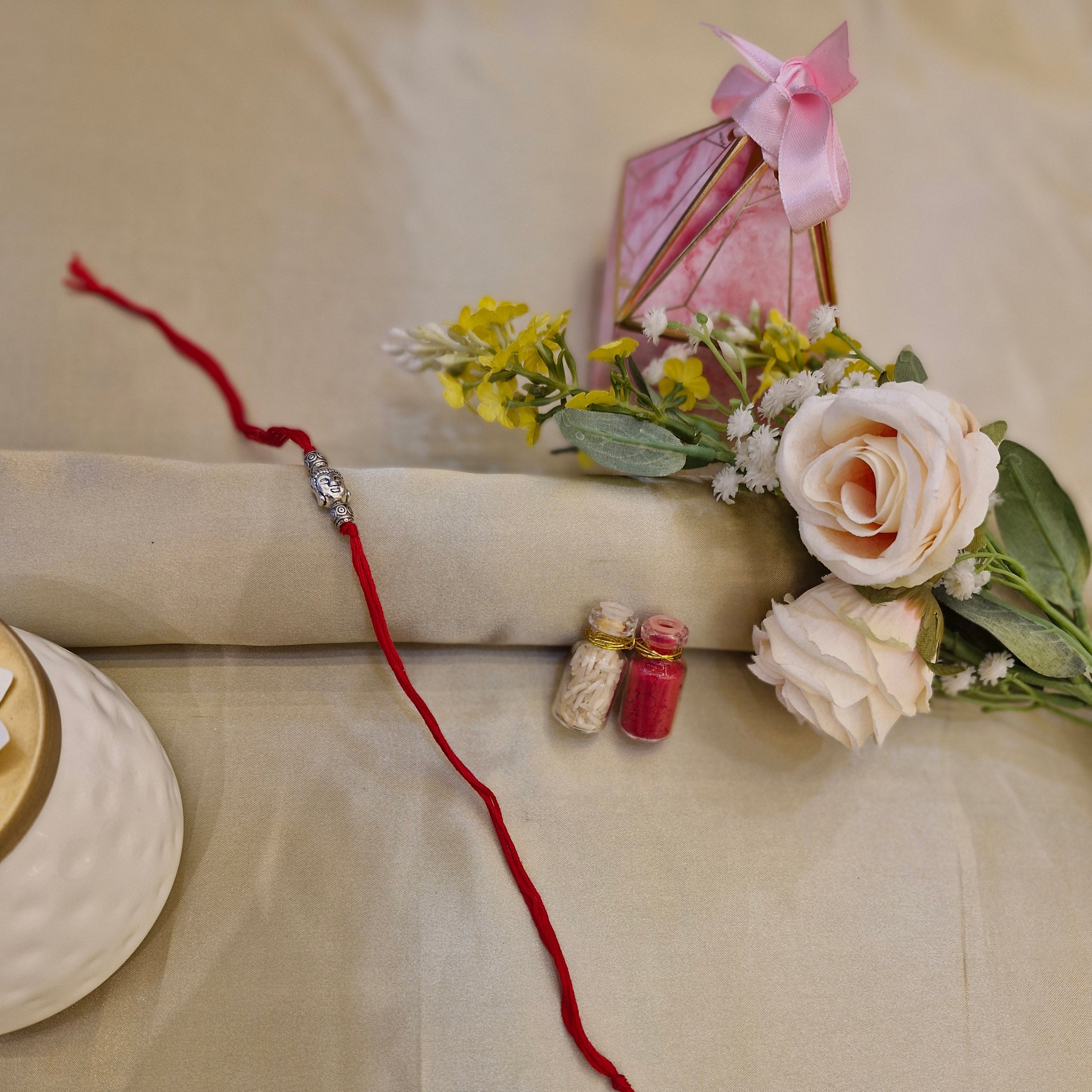 Red string with a small decorative item on a beige background